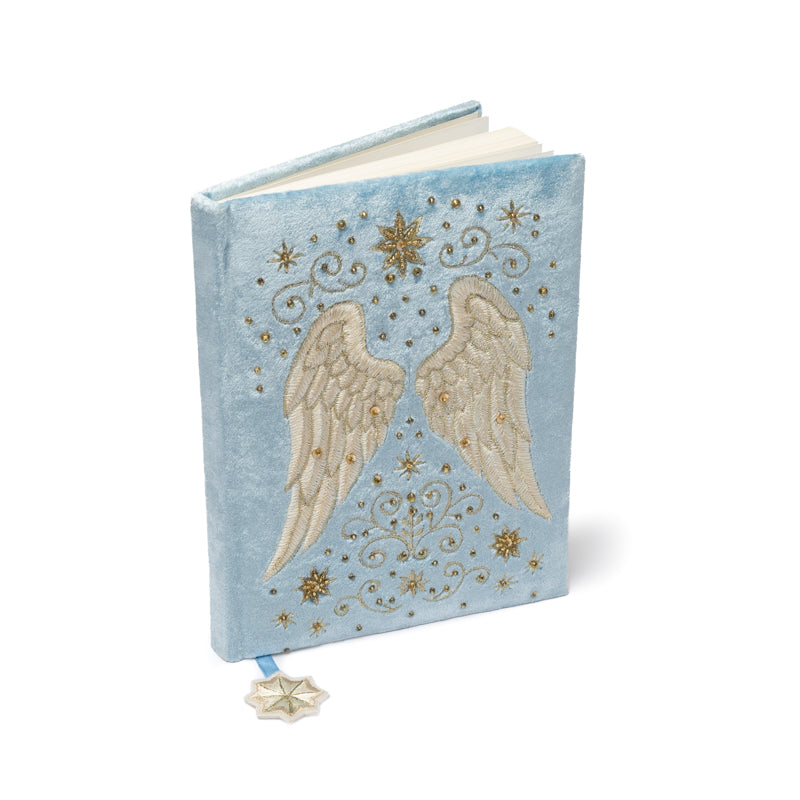 Cuaderno de terciopelo azul con alas de ángel